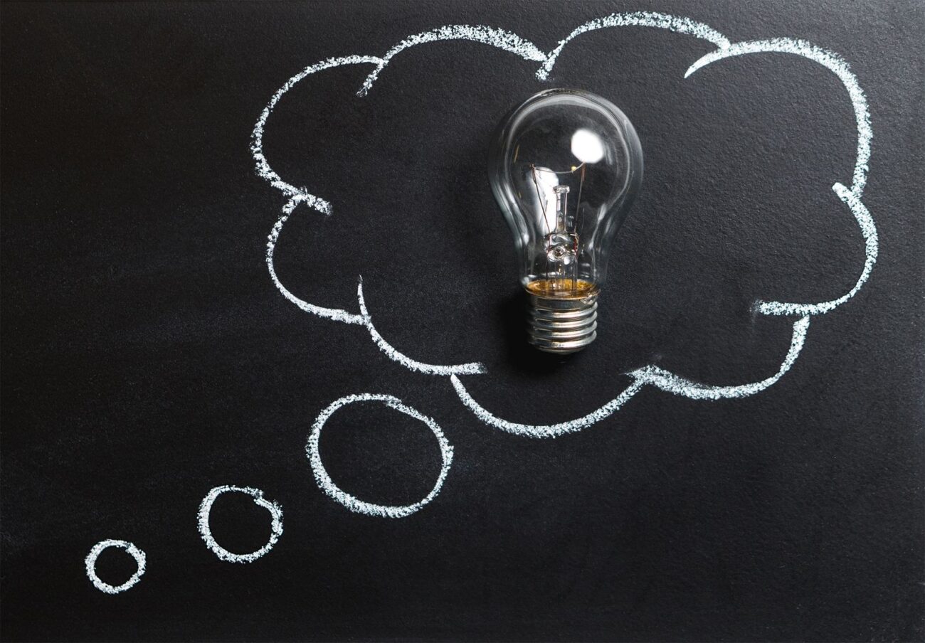 A lightbulb inside a chalk thought bubble, representing a new idea