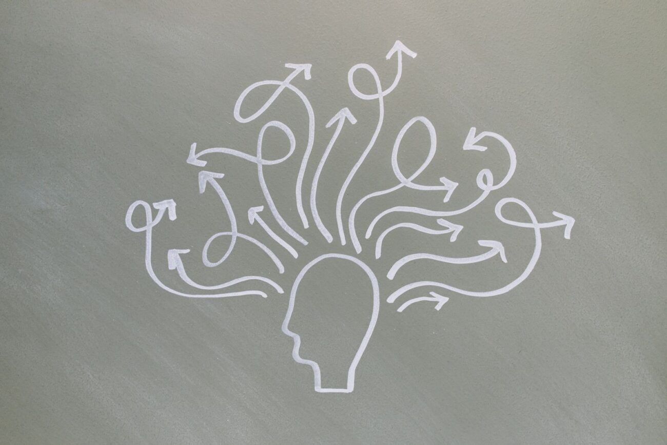 A head with arrows branching outward, showing ideas going in many direction