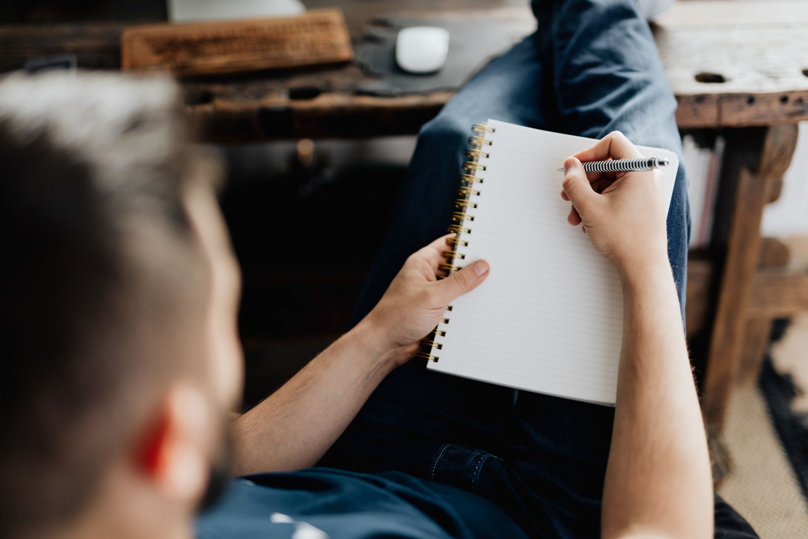 A person writing privately in a notebook, keeping personal plans out of sightImage title: keeping-plans-private
