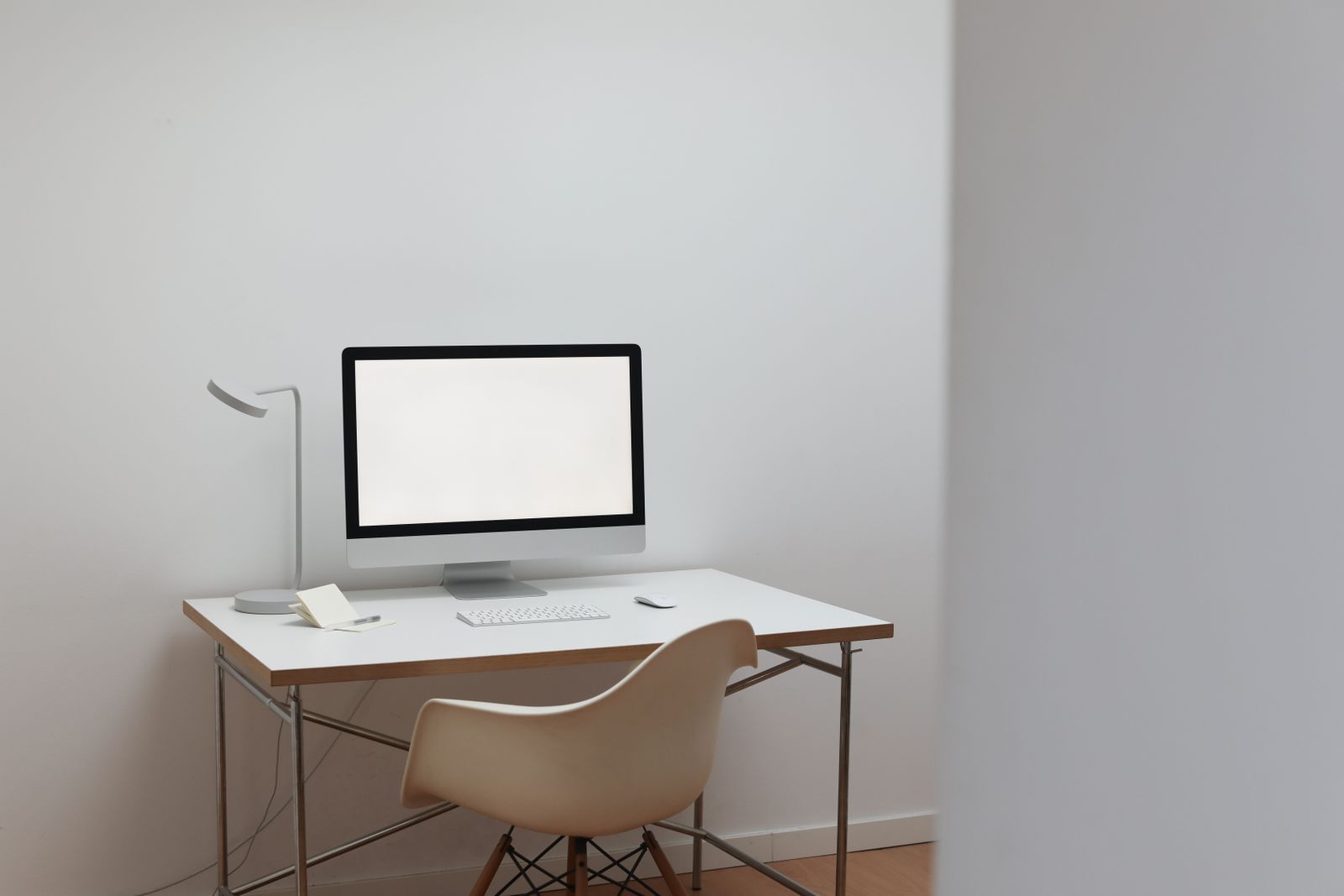 A clean, minimal desk holding only a monitor and what the work requires
