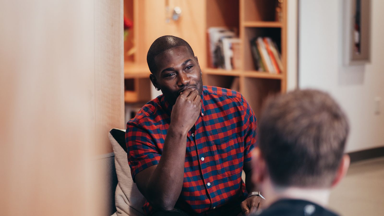 One person listening closely as another talks, taking in what is being said