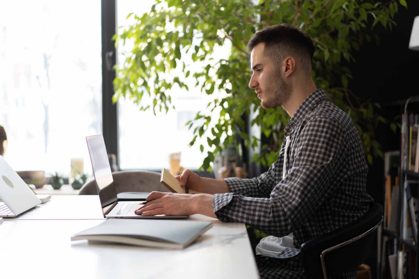 A person working calmly and focused at a laptop in a workplace