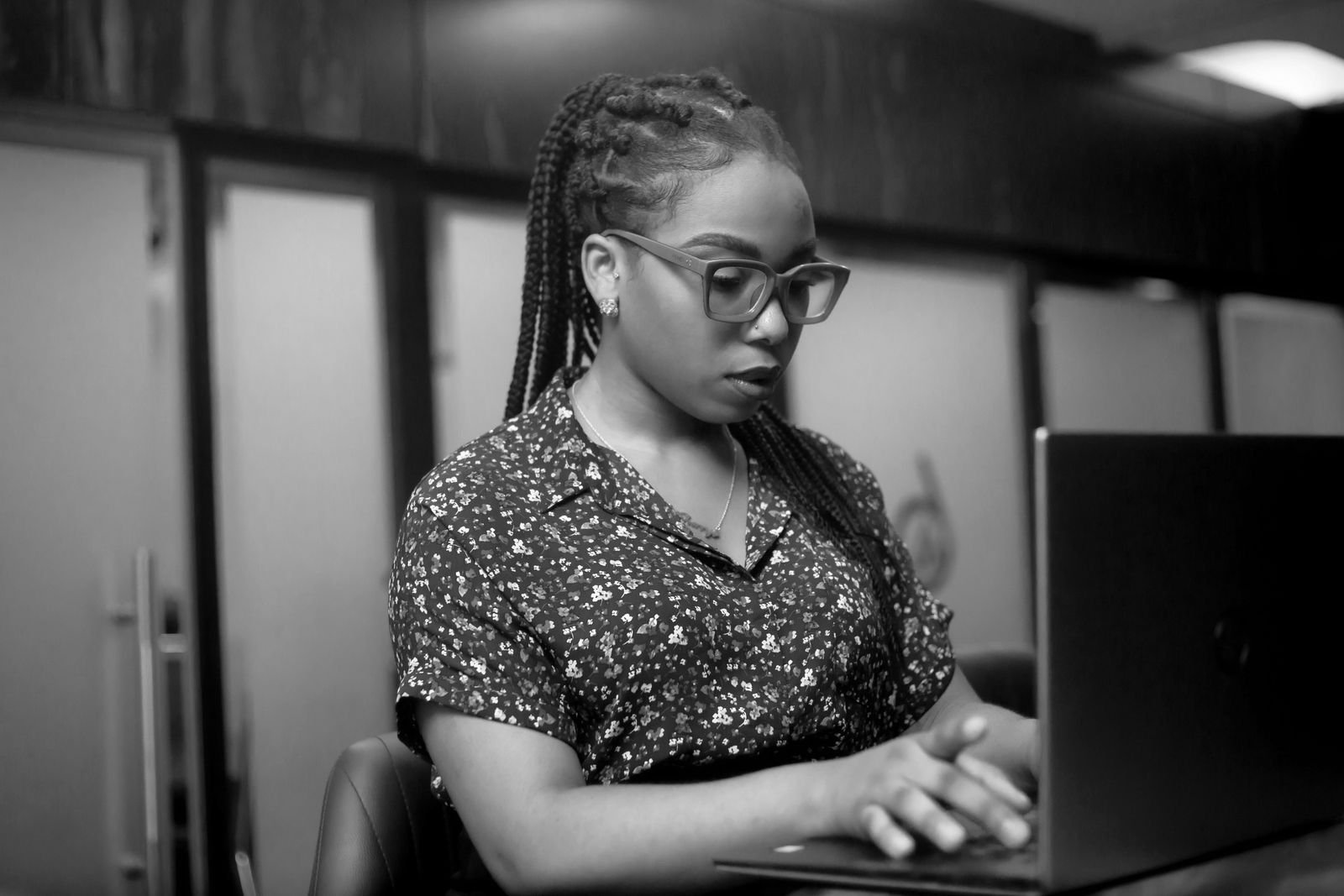 A person concentrating on work at a laptop